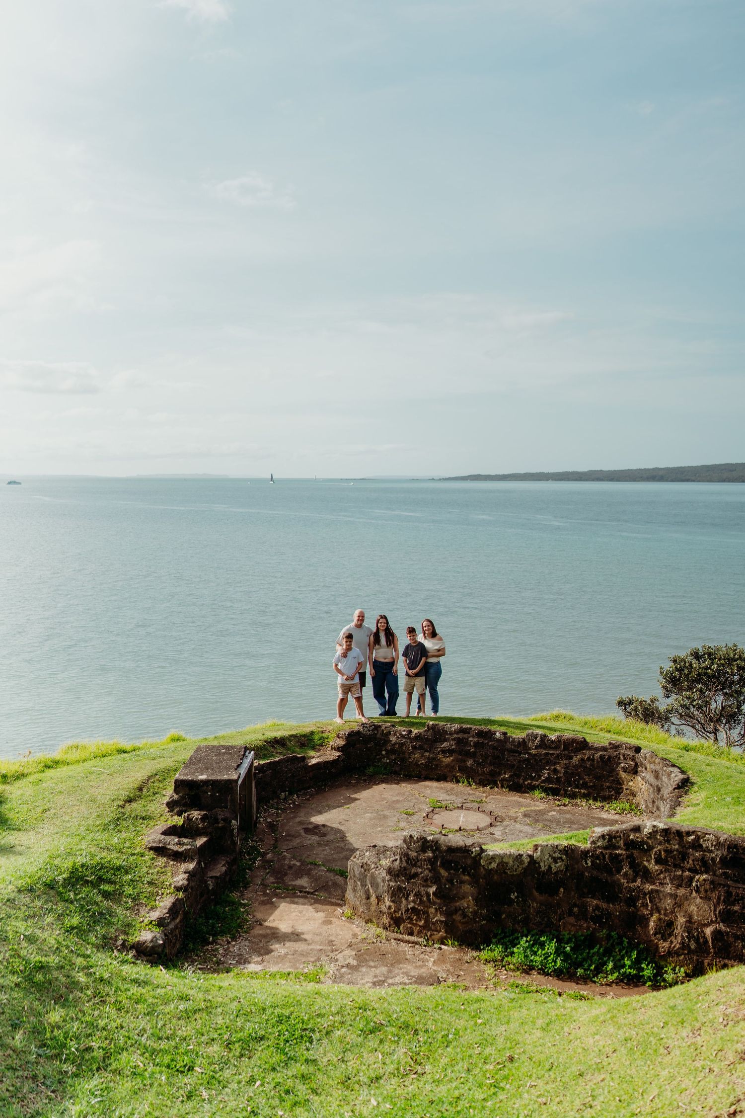 Grassy coastal cliffs overlooking the ocean with scenic walking paths and visitors enjoying the panoramic views.