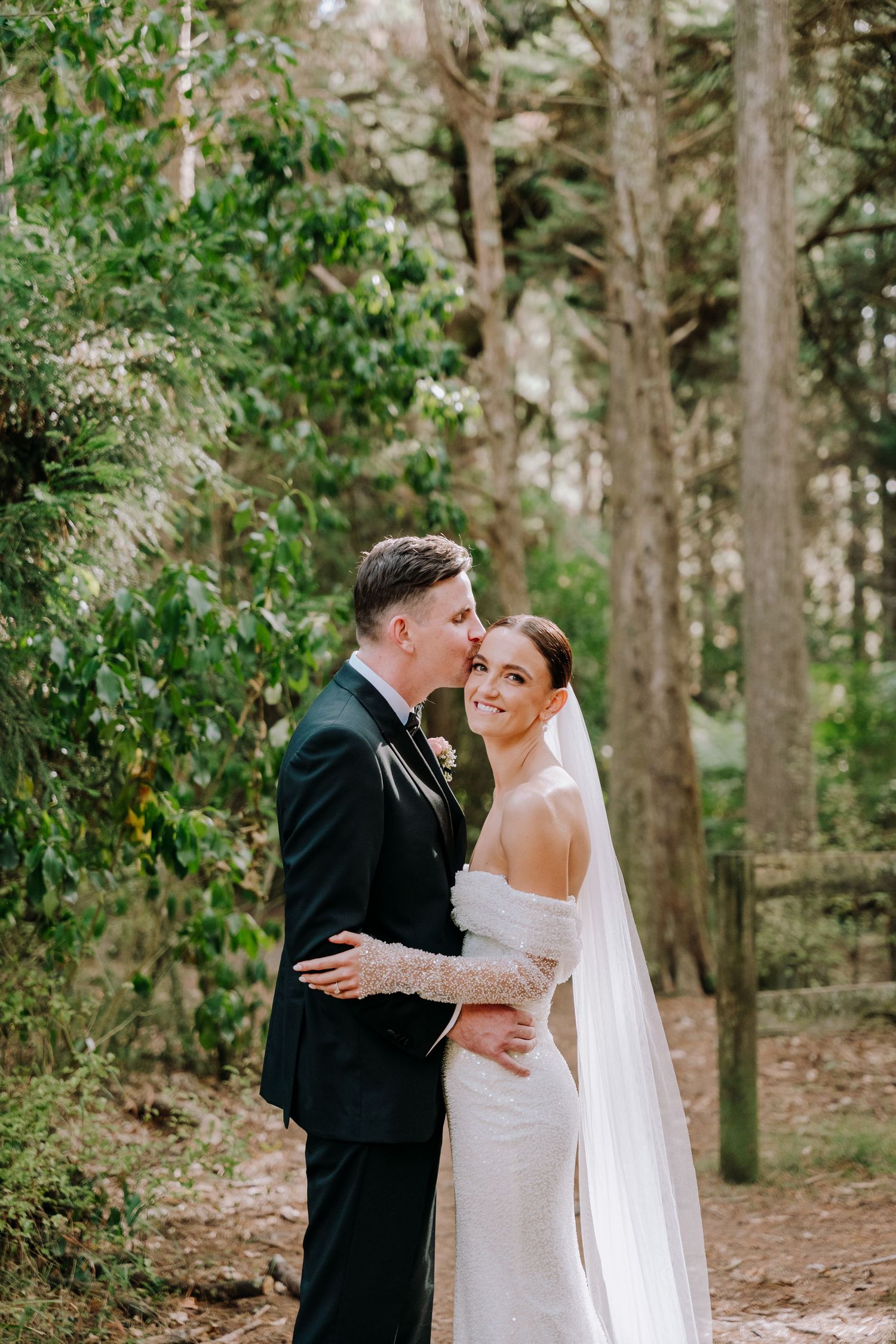 Romantic wedding portraits captured in a serene wooded setting.