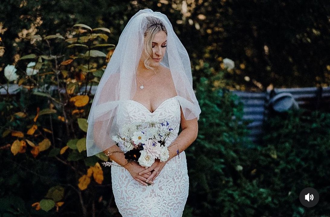 Bridal portraits in garden setting with classic white gown and bouquet.