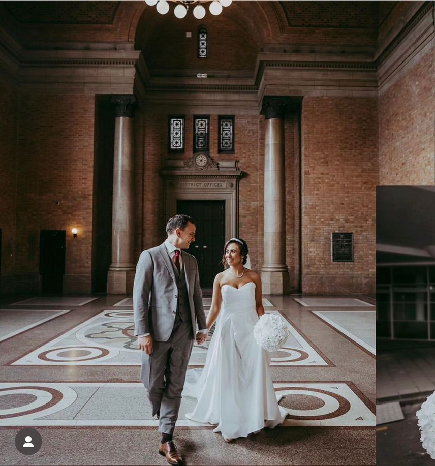 Elegant wedding photography session in historic brick building with ornate floor patterns.