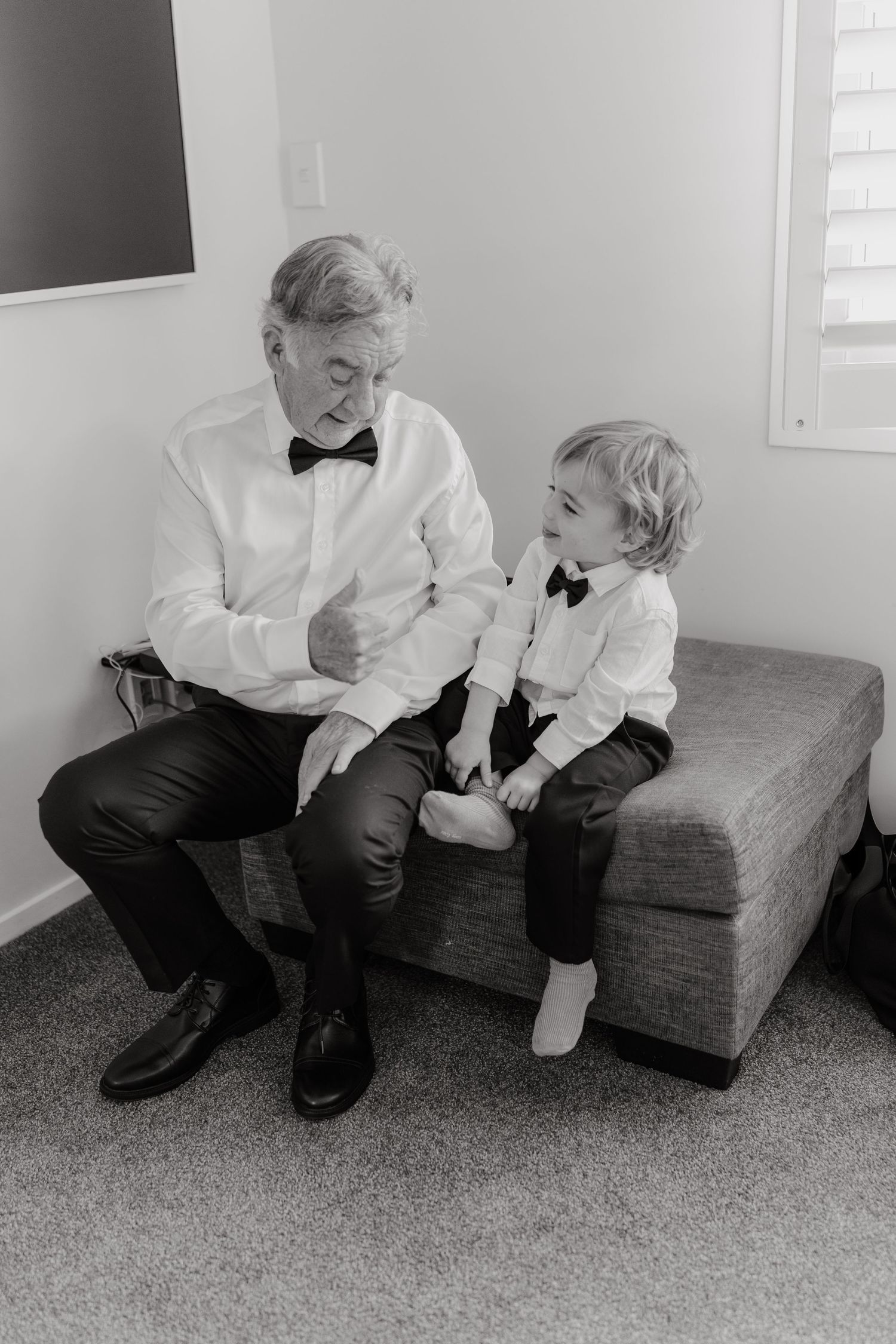Black and white sequence of tender moments between two people sitting on couch.