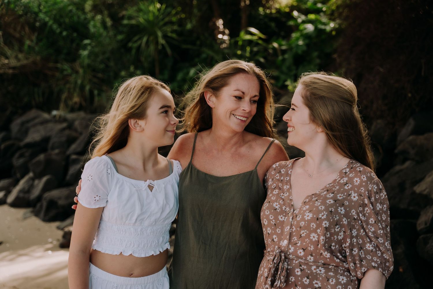 Candid family moments captured during a beach photo session.