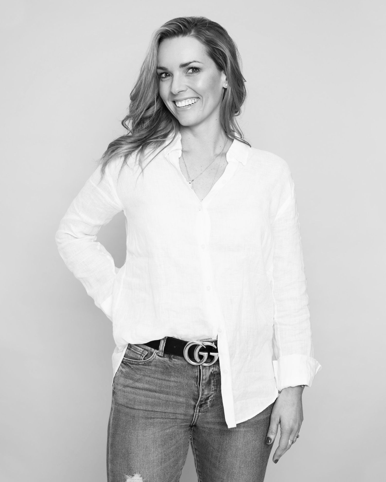Fashion portraits of a woman in a classic white button-down shirt and jeans against a white background.