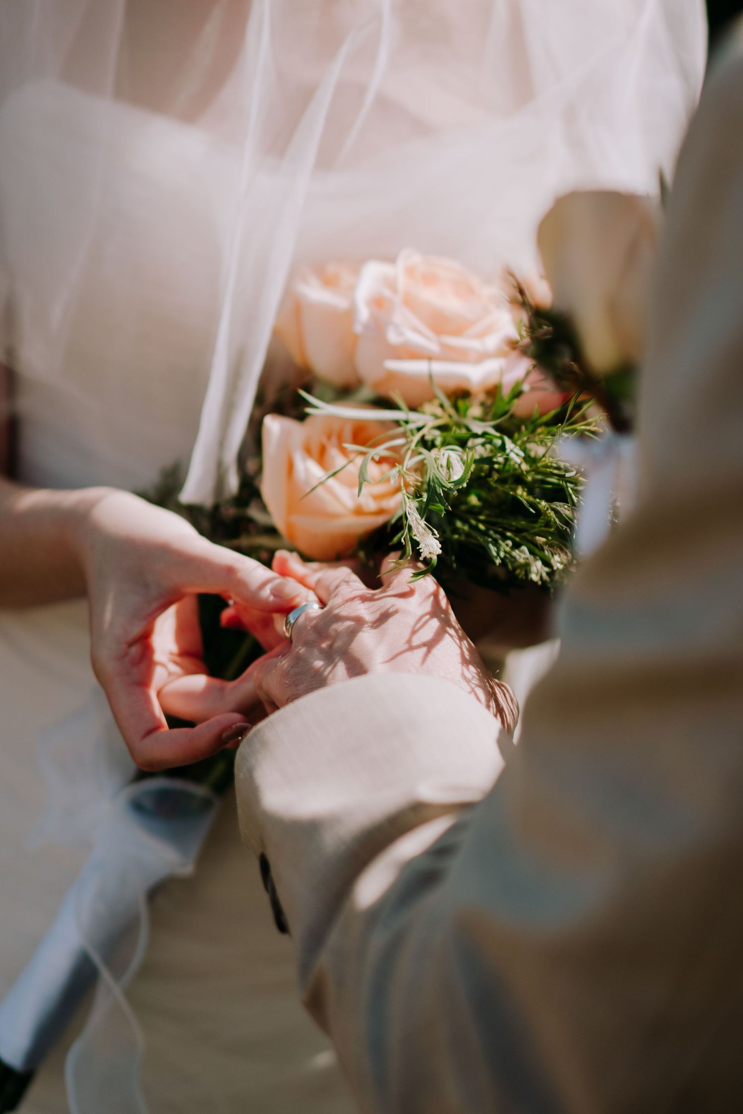 Close-up shot of delicate floral details being arranged at a wedding ceremony.