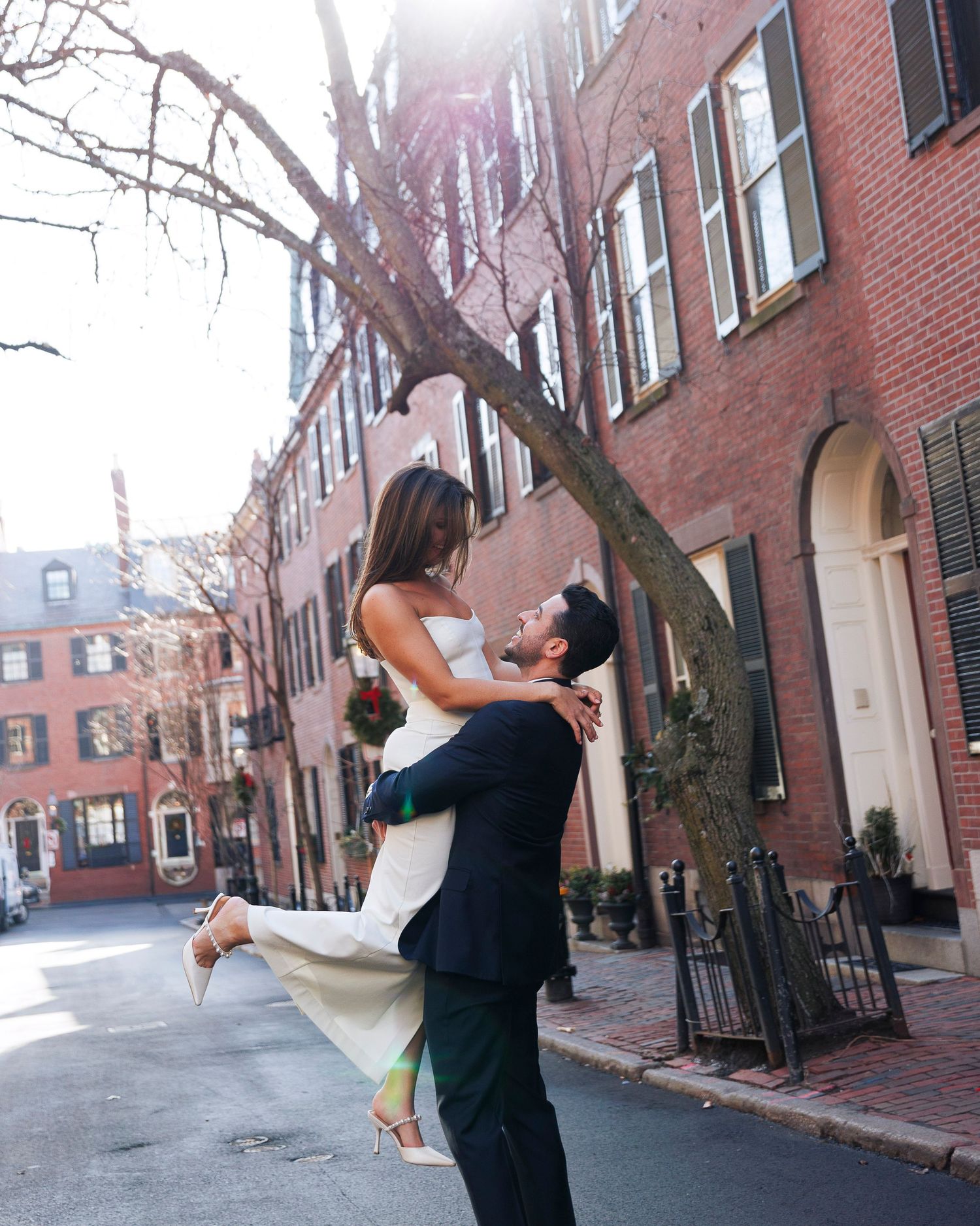 A sequence of five photos shows a couple dancing together on a historic brick-lined street in Boston.