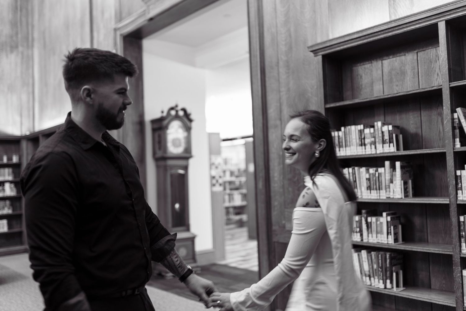 A series of black and white photos showing people interacting in what appears to be a library or office setting.