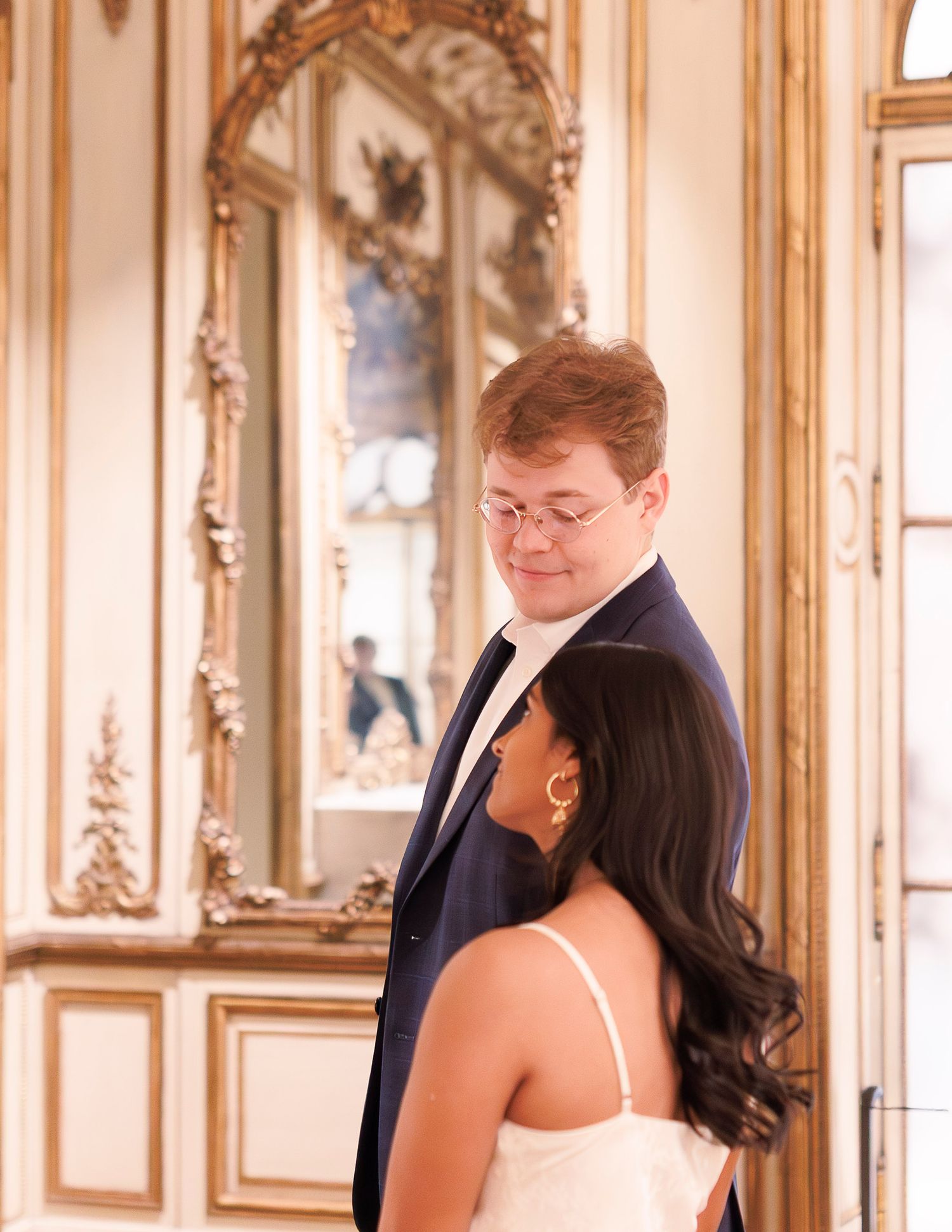 Elegant couple dancing together in an ornate ballroom with gilded mirrors and classical decor in the MFA Boston.
