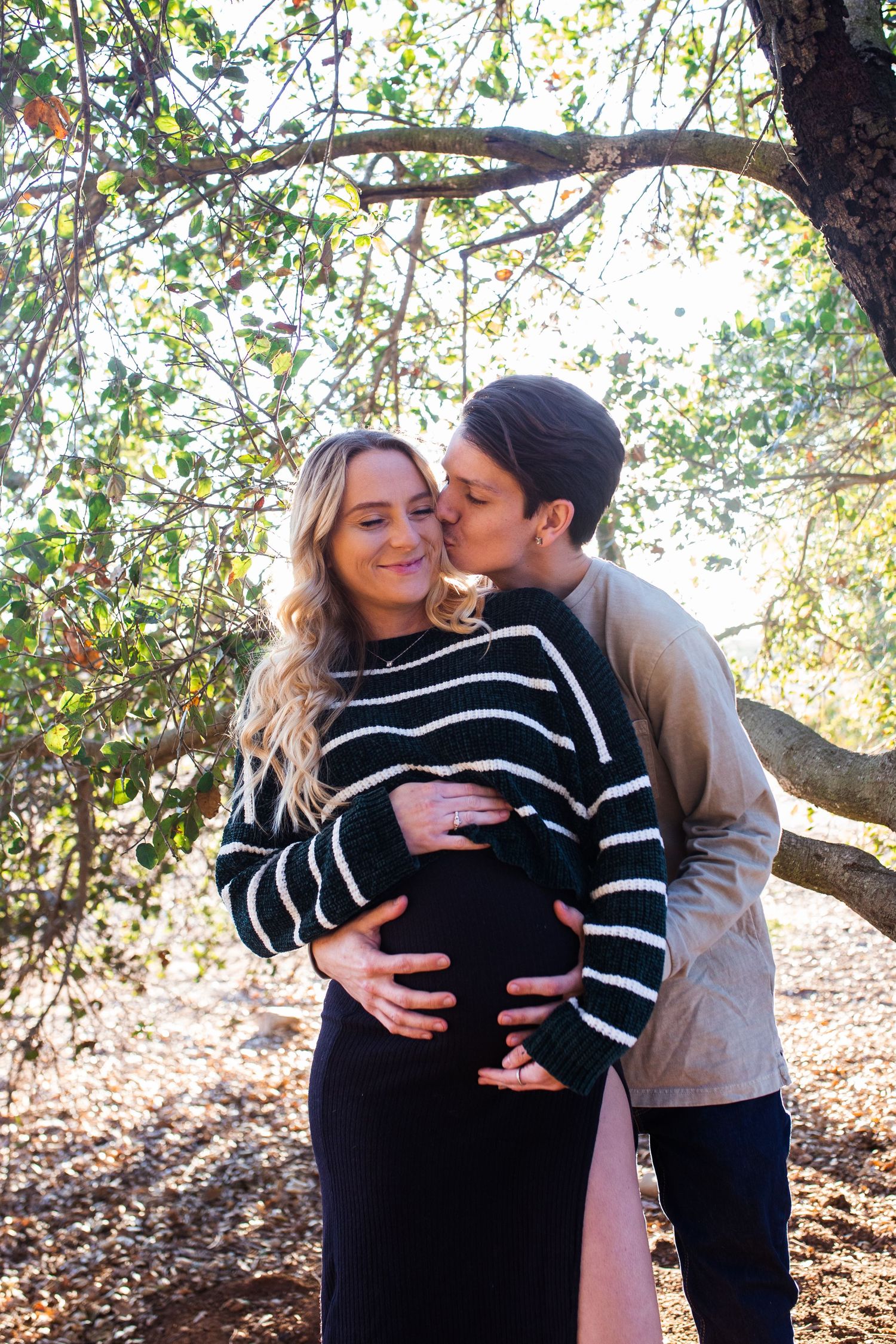 Maternity photoshoot sequence showing tender moments between couple under autumn trees.