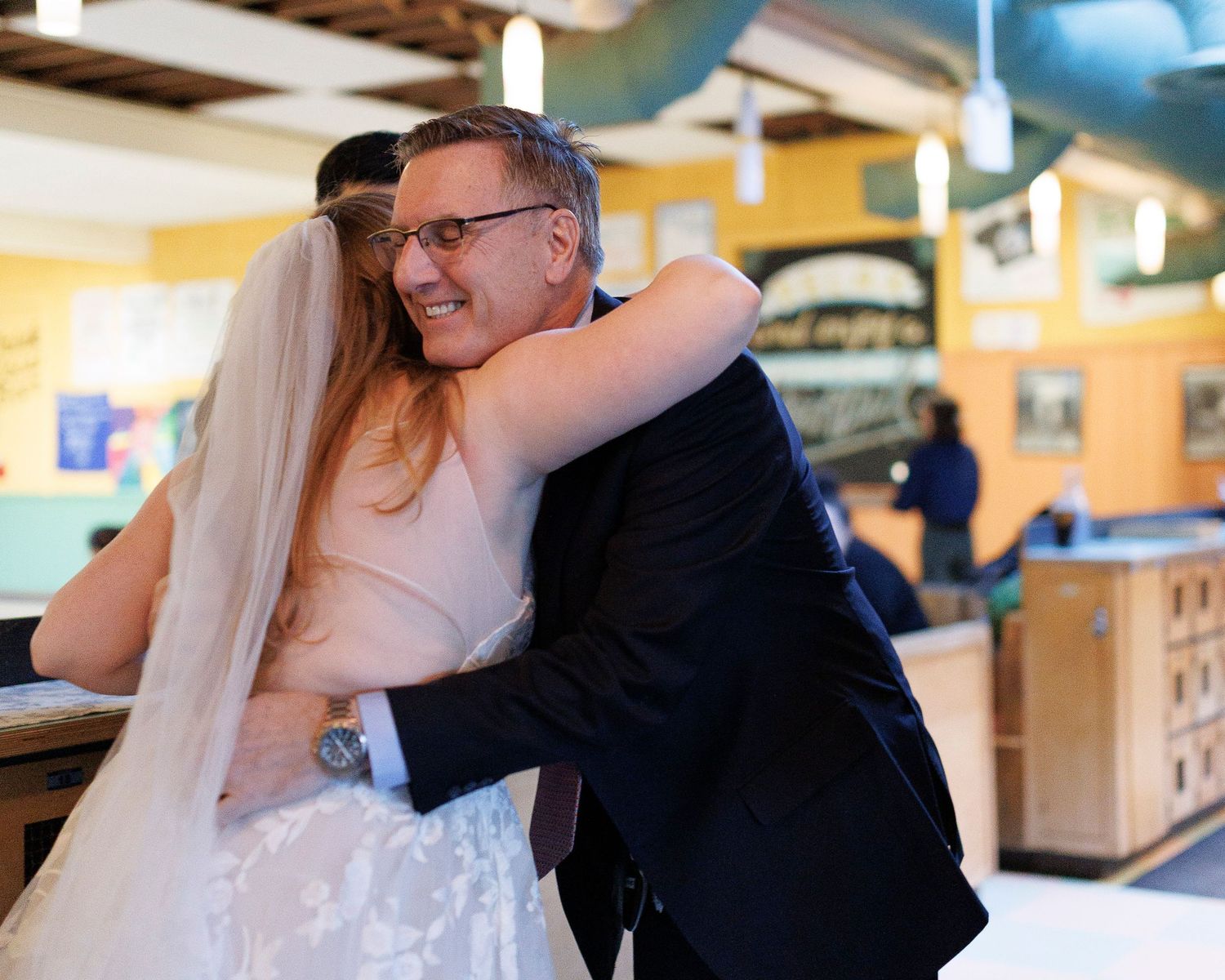 A couple in wedding attire embrace and share a tender moment during their celebration.