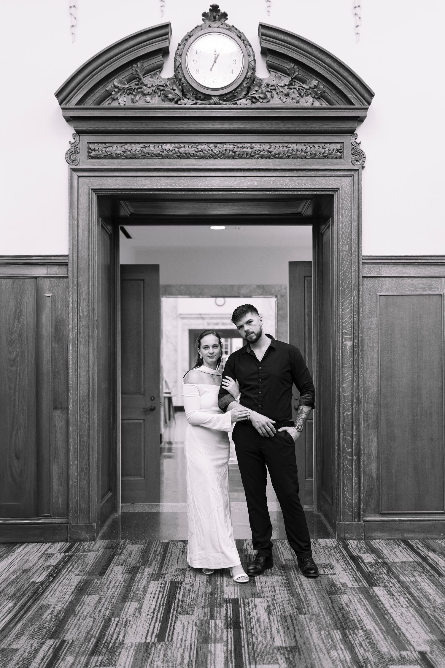 A series of black and white photos showing a couple dancing and posing in an elegant room with ornate doorways and wood floors.