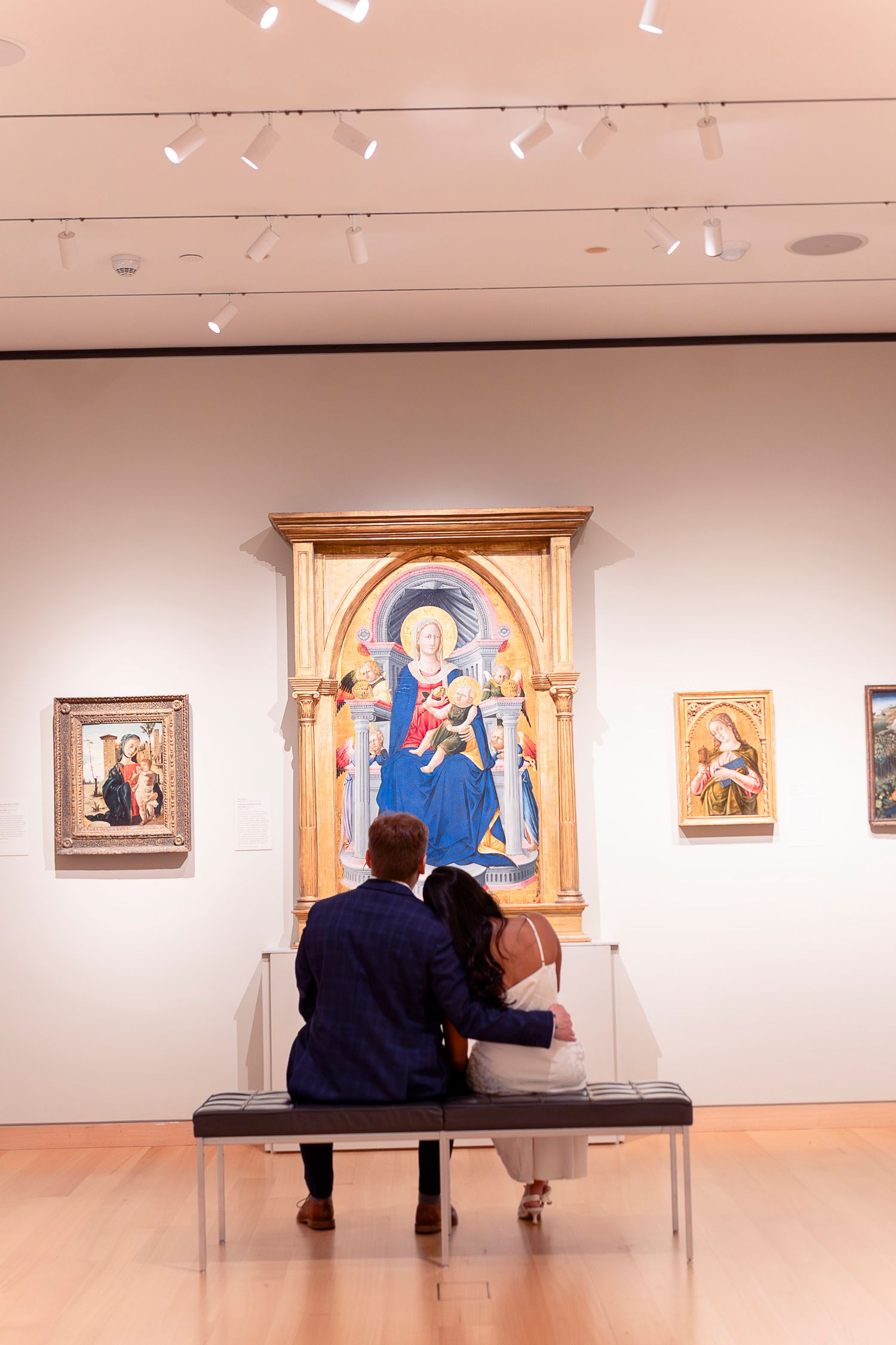 A series of art gallery scenes showing visitors viewing religious paintings and artwork displayed on white gallery walls.