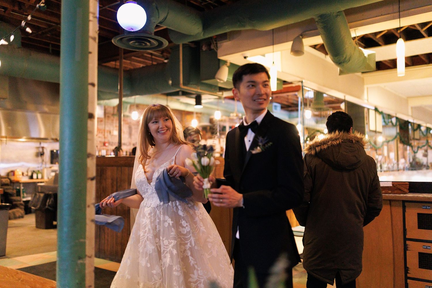 Couples dancing together at an indoor venue with warm lighting and exposed ceiling beams.