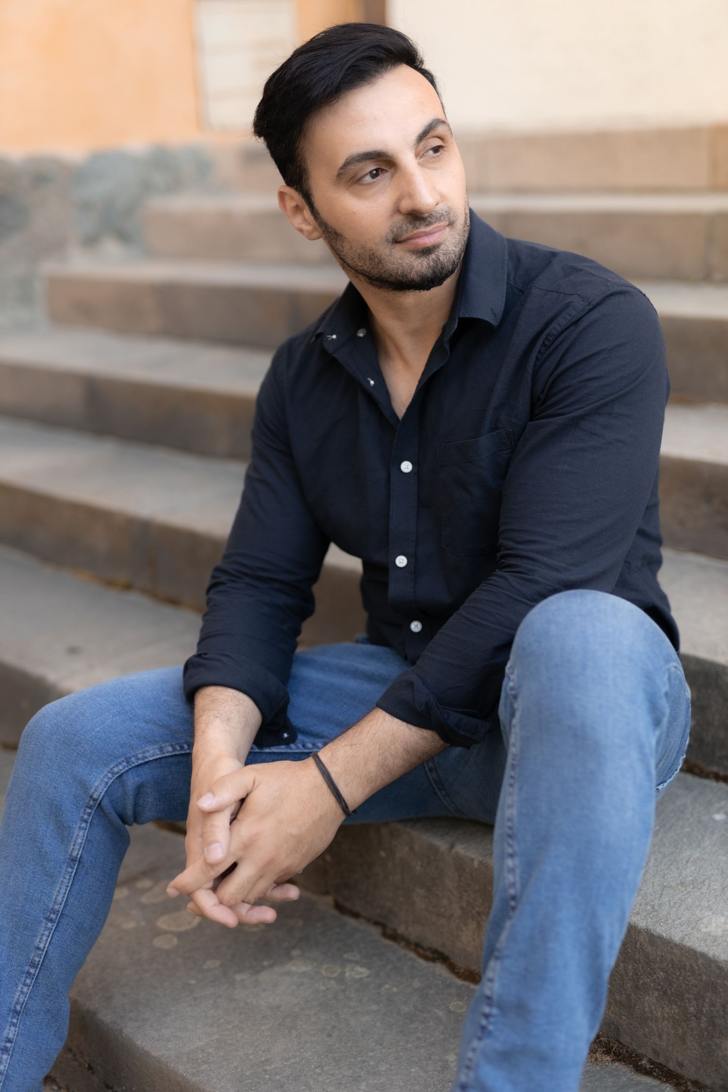 Casual portrait session on concrete steps featuring relaxed poses in denim and navy attire.