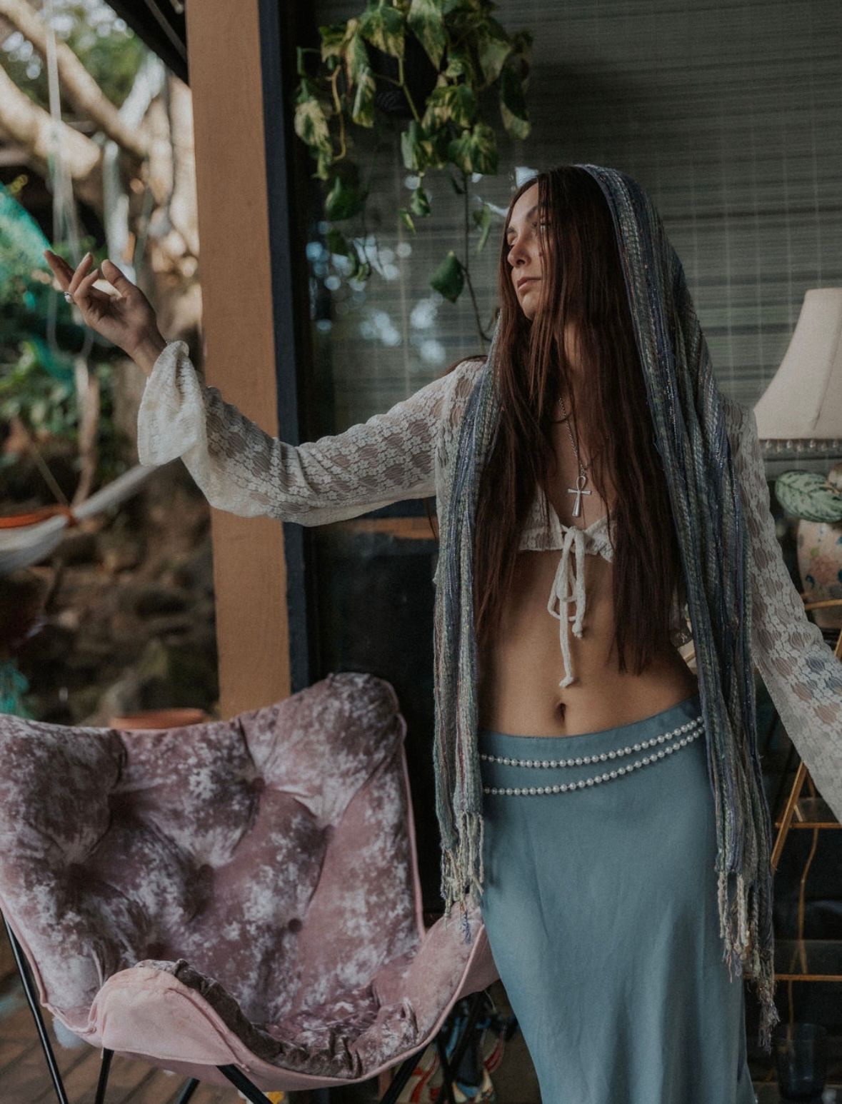 Bohemian style photoshoot with long hair and flowing fabric details.