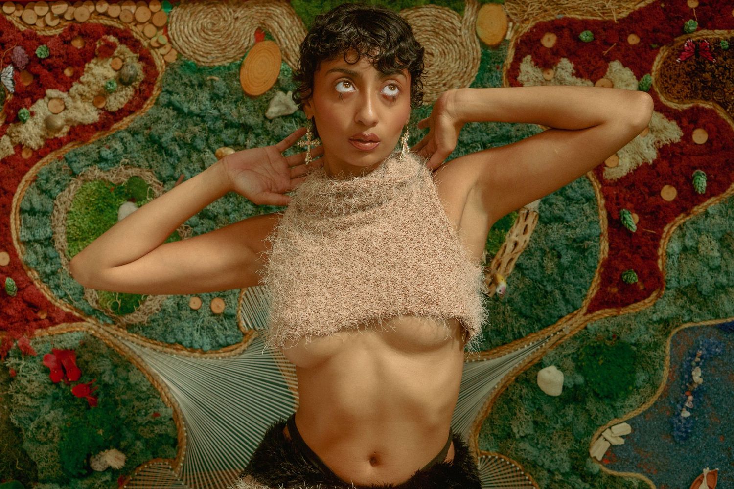 A series of artistic photographs showing a person posing against colorful floral wallpaper in various positions.