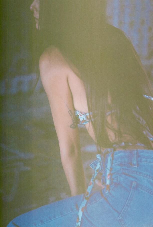 Dreamy vintage-style photo showing denim and long hair in soft focus.