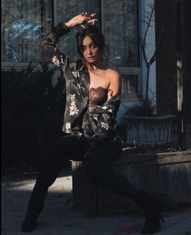 Dramatic outdoor portrait session in dark floral outfit with moody lighting.