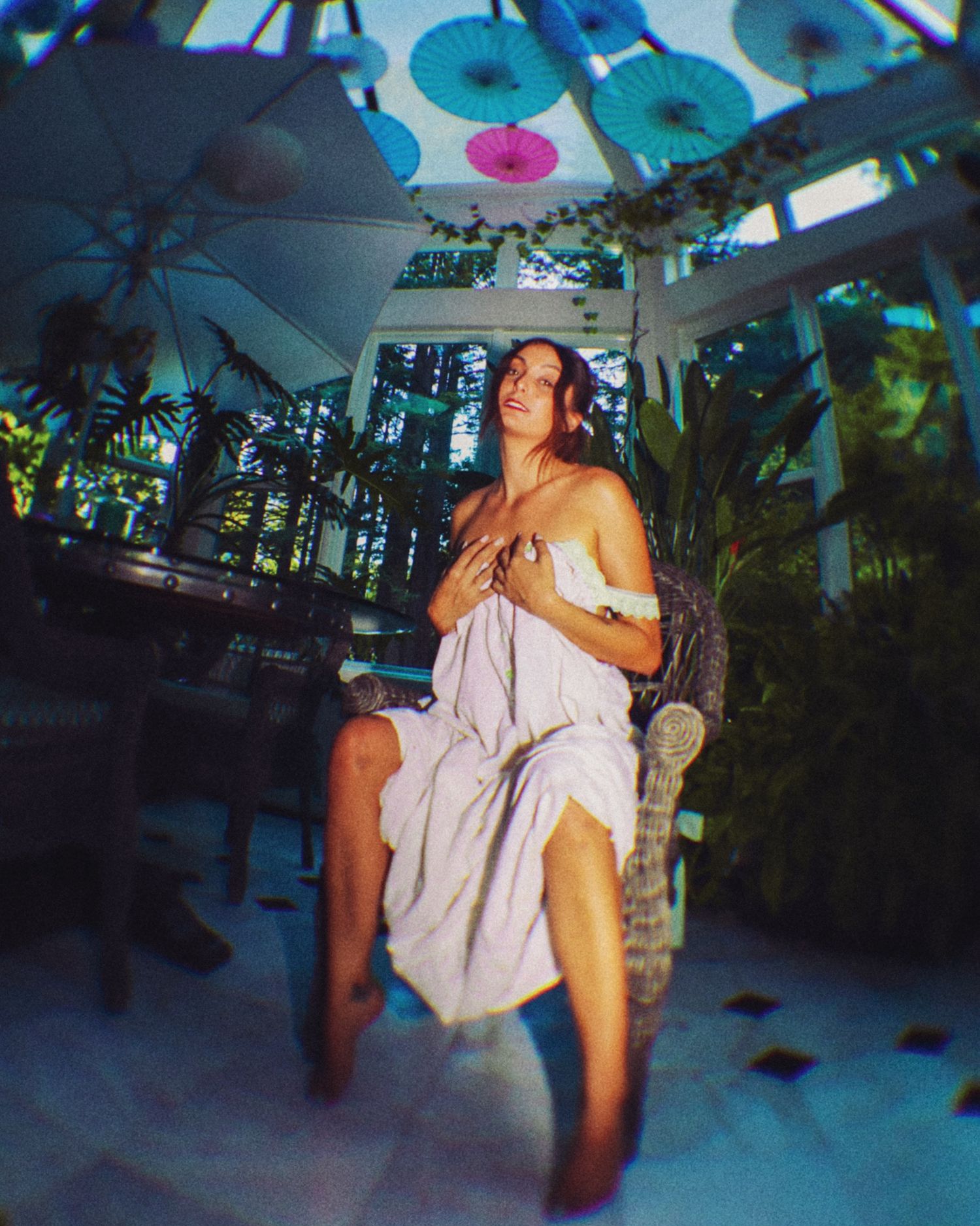 Dreamy nightclub scene with blue lighting and tropical decor.