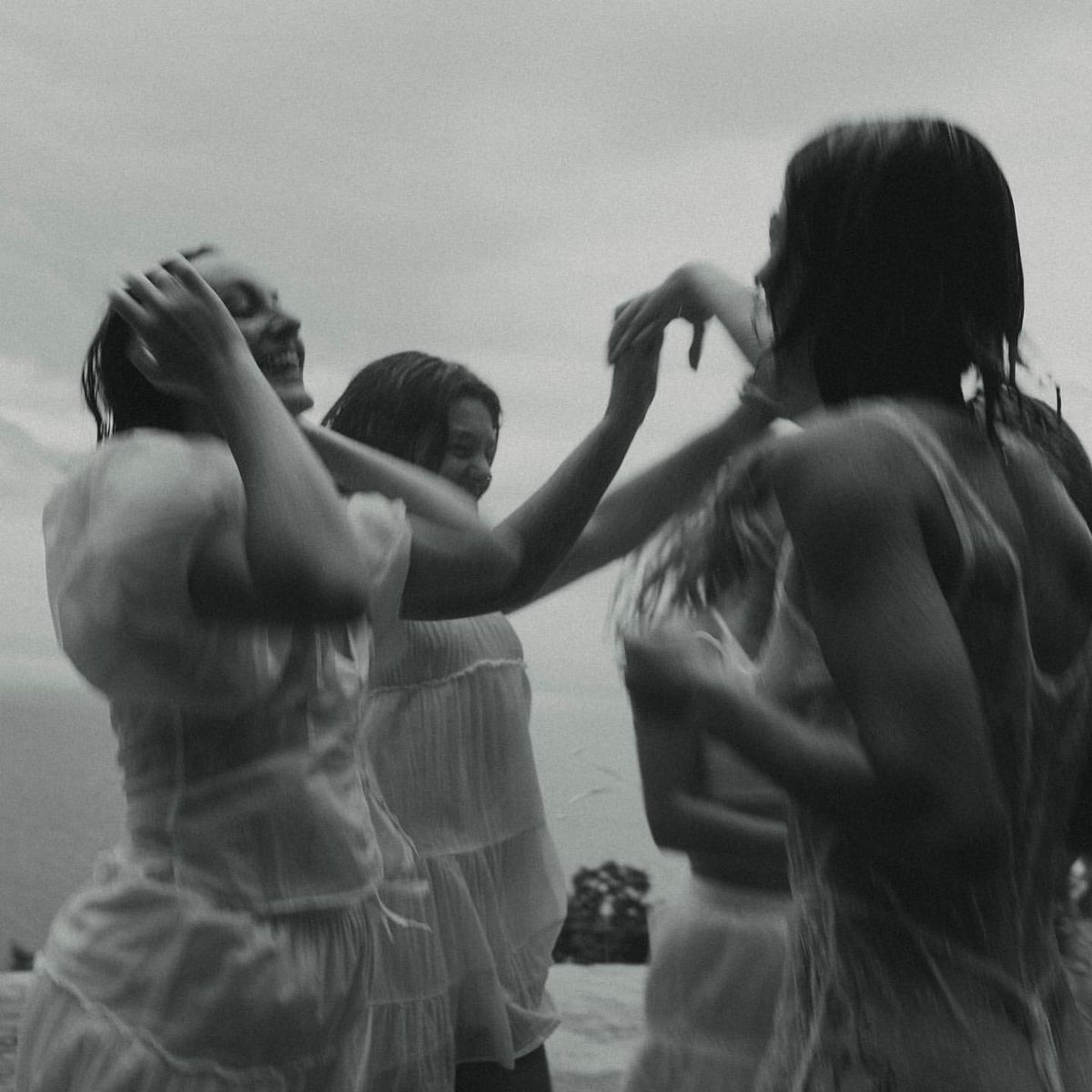 A group performs synchronized movements against a misty outdoor backdrop.