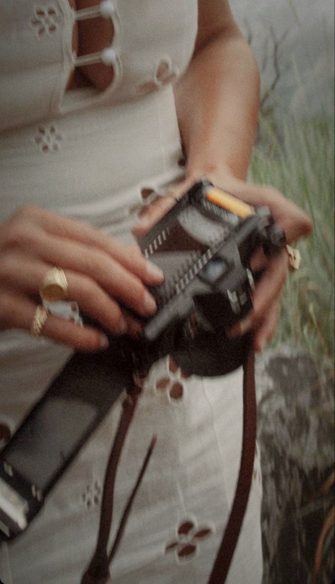 Close-up shot of hands holding a vintage camera with motion blur effect.