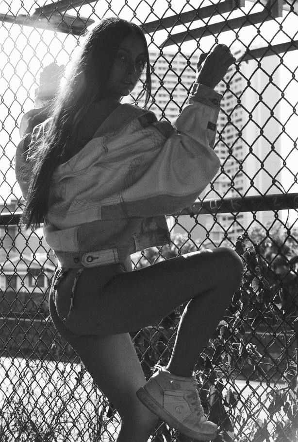 Artistic black and white shot climbing chain link fence.