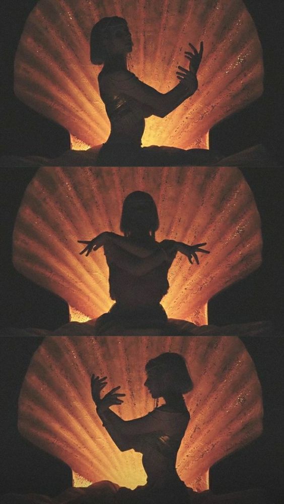 Silhouette of a dancer performing expressive poses against a glowing orange and yellow radiant light background in three frames.
