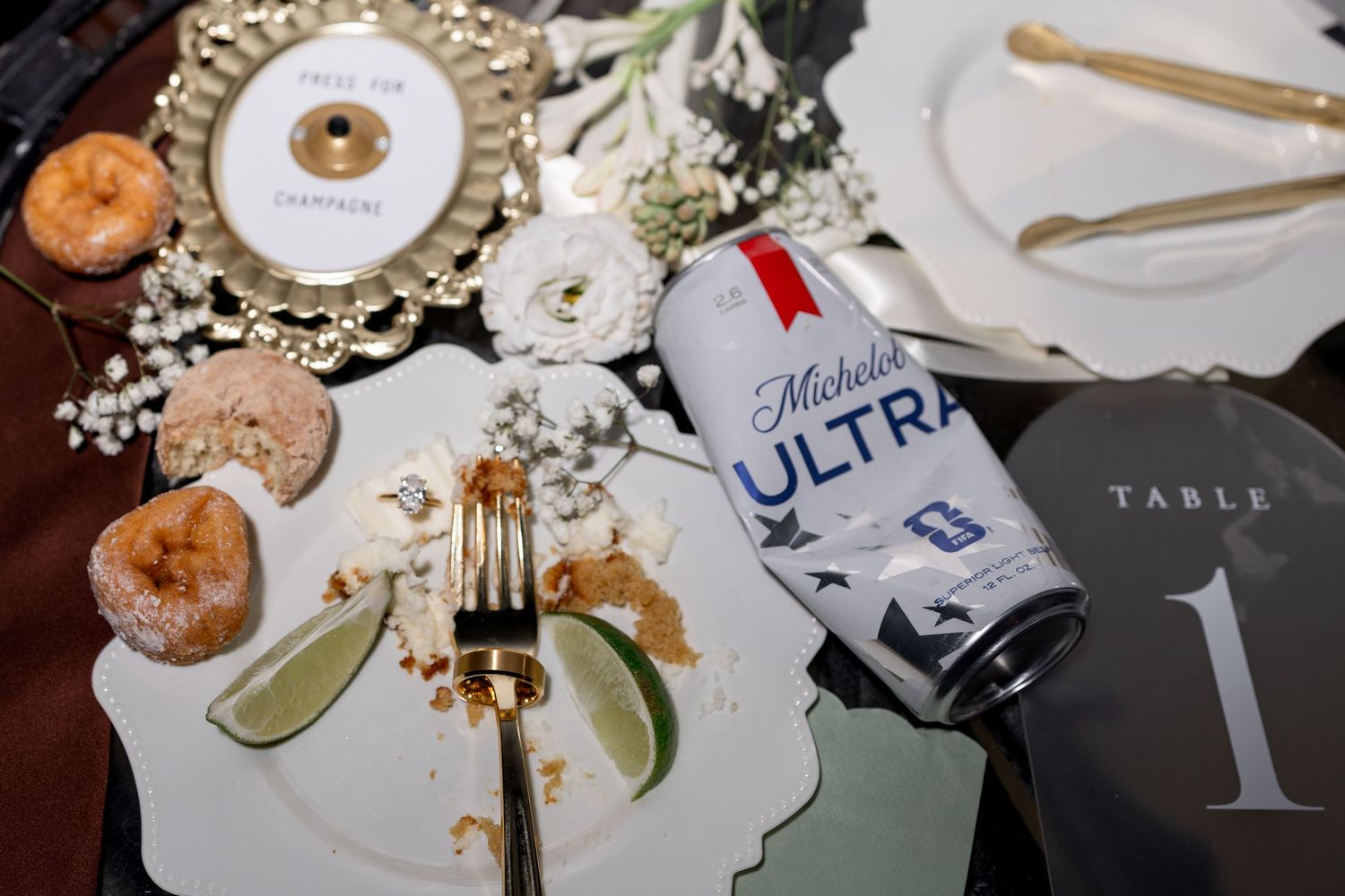 Wedding reception table with Michelob Ultra beer can, donuts, and floral centerpiece at Table 1.