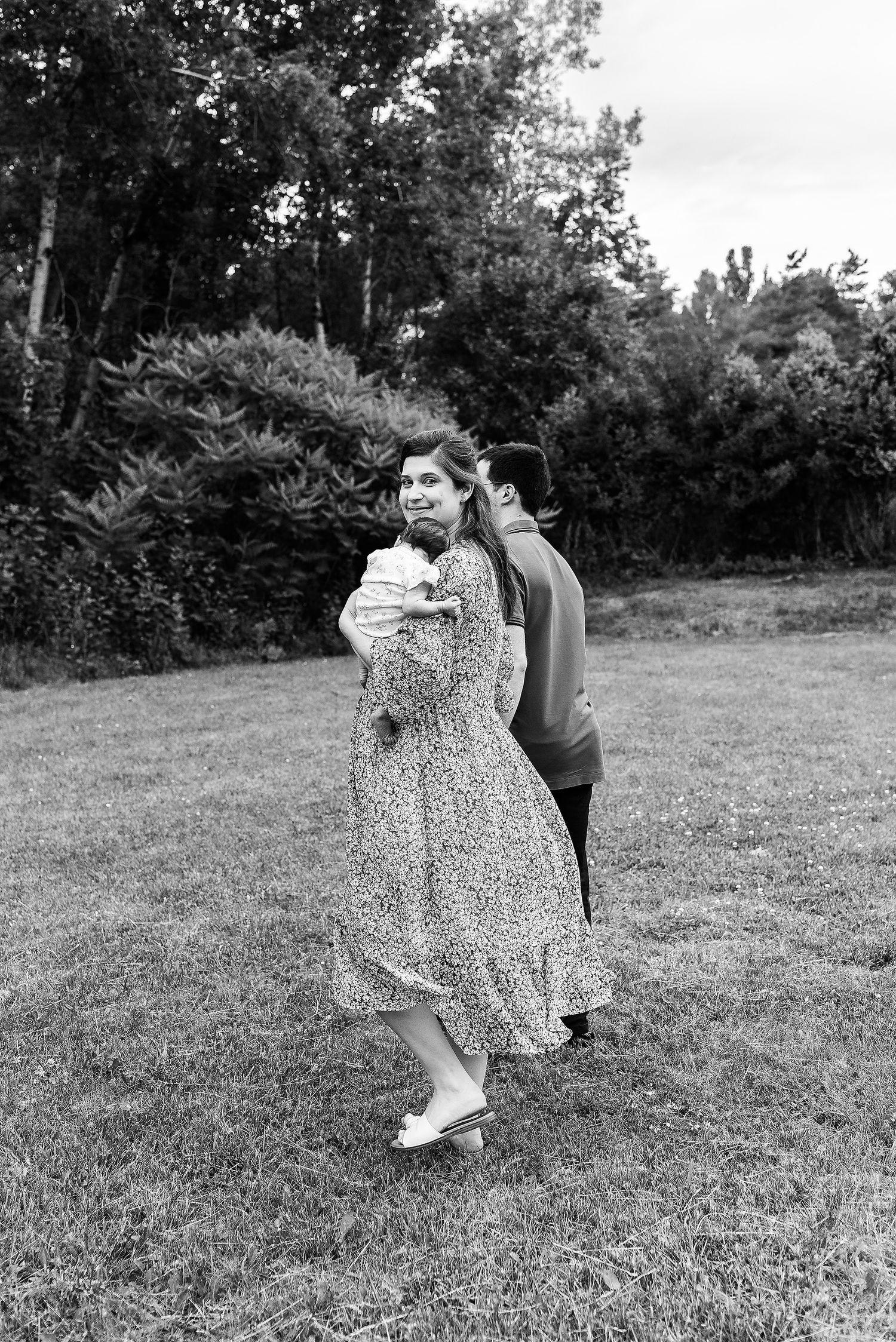 Dancing couple captured in black and white on a grassy field.