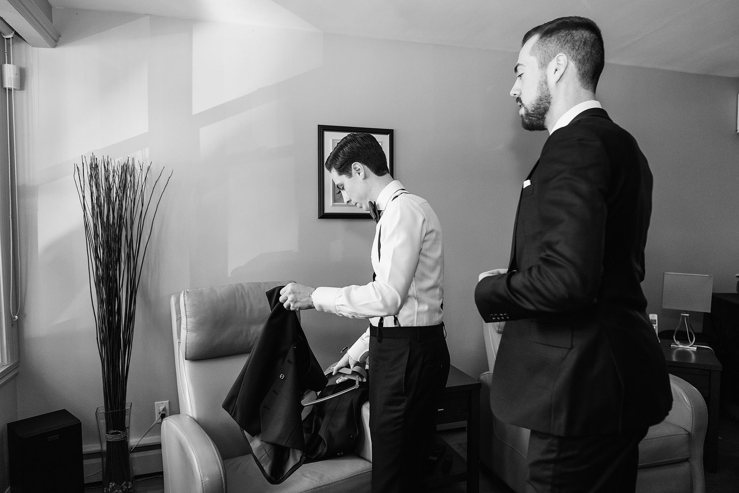 Professional black and white photograph of people reviewing documents in an office setting.