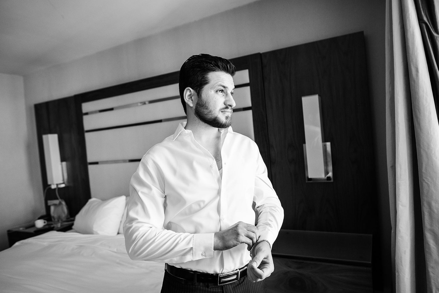 A series of black and white photographs showing someone in a white shirt adjusting their tie in a mirror.