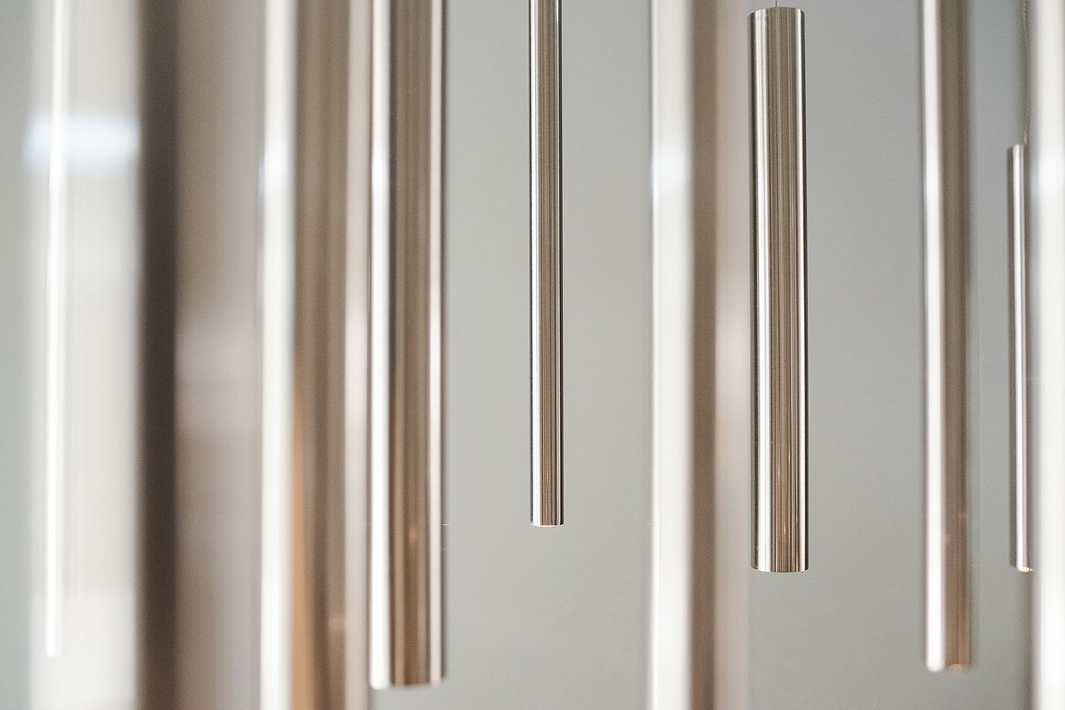 Abstract architectural detail showing vertical lines and shadows on a white modern interior wall.