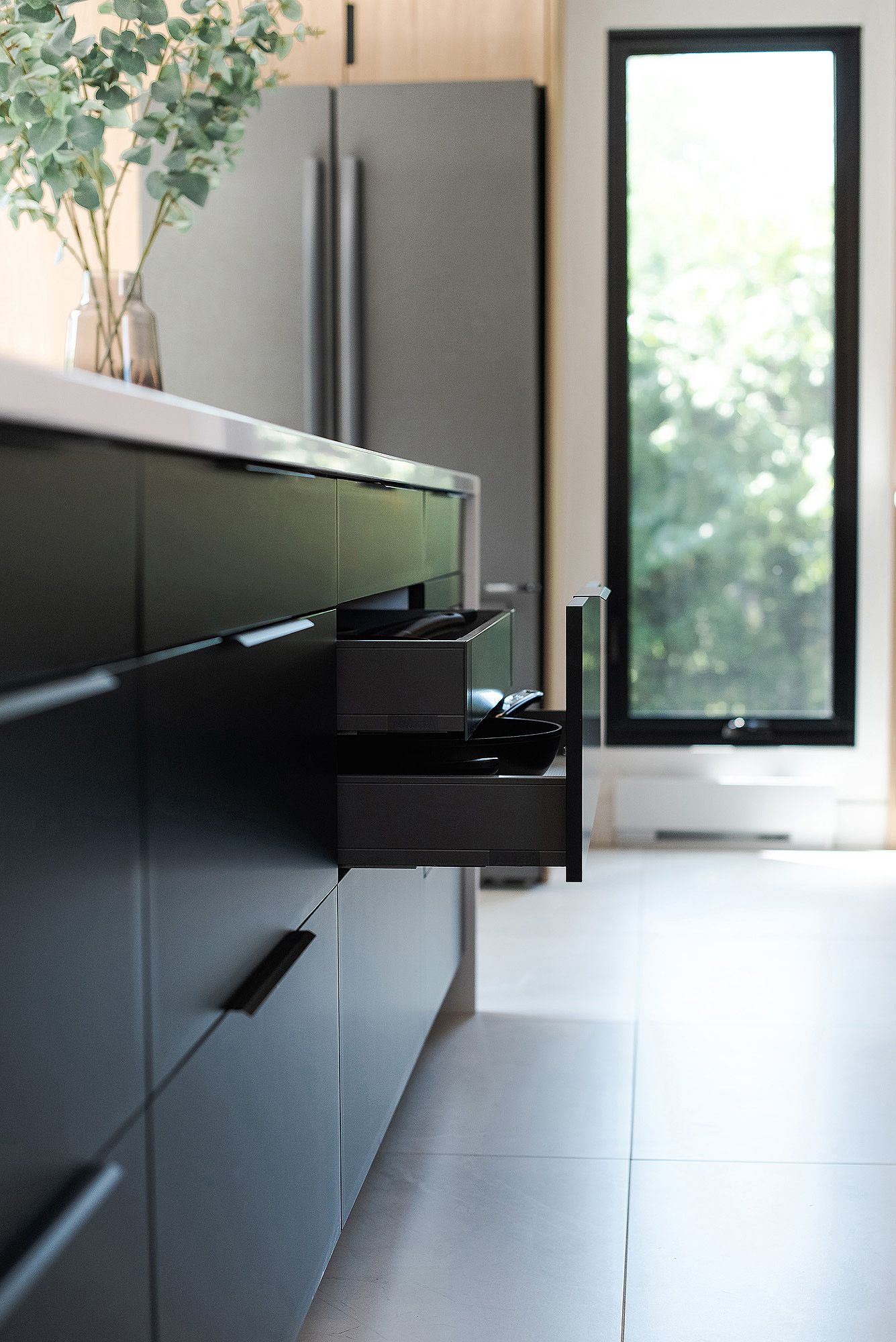 Modern black floating entertainment unit mounted on wall with minimalist design and clean lines.