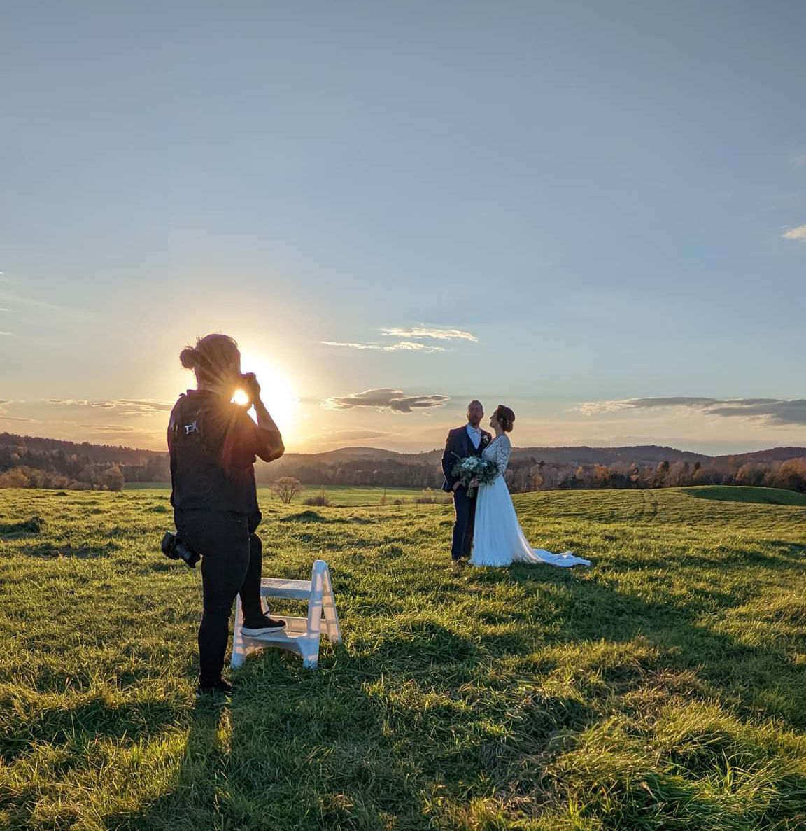 Wedding photography session in a sunlit field during golden hour.