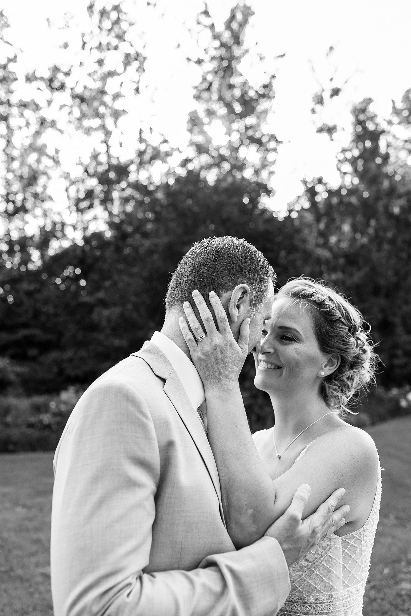 A romantic sequence of black and white photos showing a couple sharing a tender kiss outdoors.