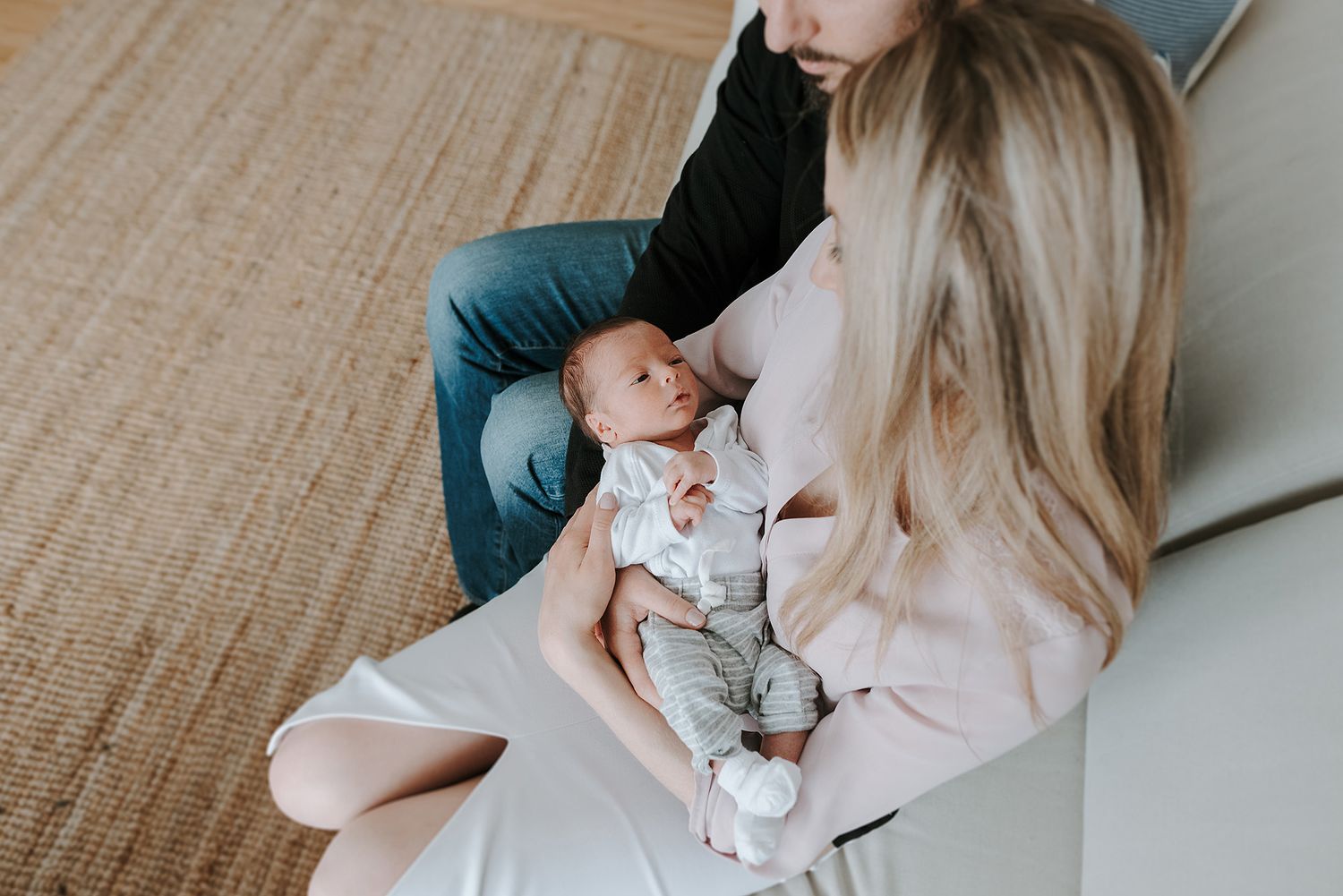 Gentle moments captured between parent and newborn in soft natural light.