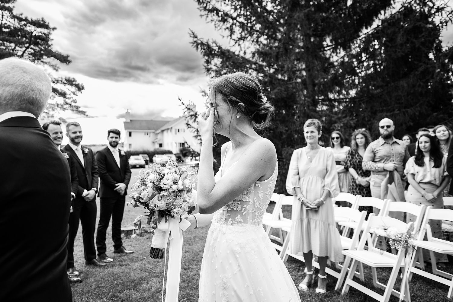 Black and white photo collage showing joyful moments from an outdoor wedding ceremony and reception.