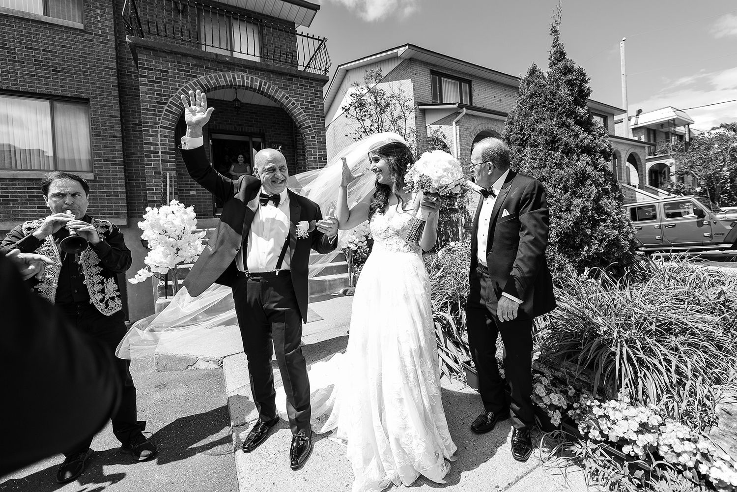 A collection of candid black and white wedding moments showing celebrations and interactions between guests and the couple.