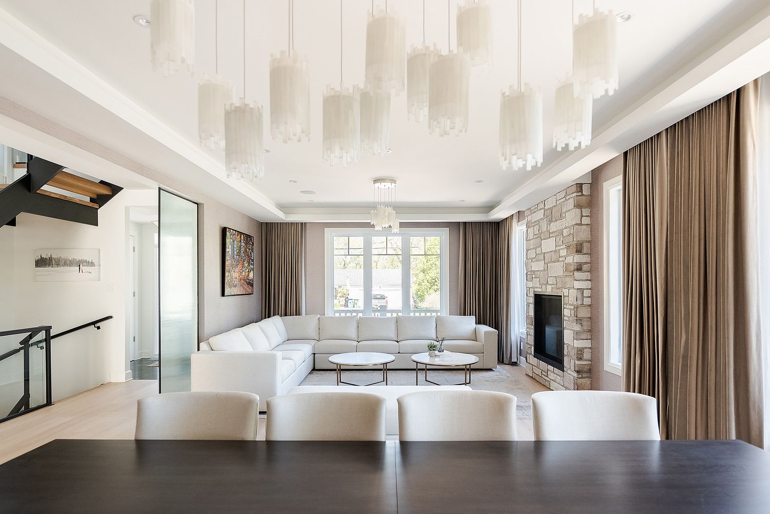 Spacious open concept living area with high ceilings and large windows showcasing modern architectural details.