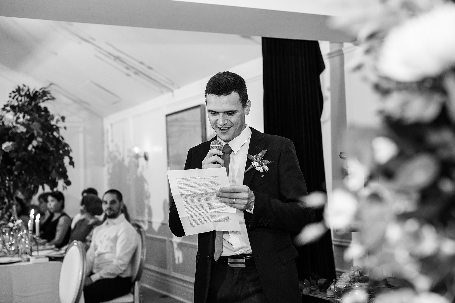 Black and white photo collage showing people in formal attire during a business meeting or event.
