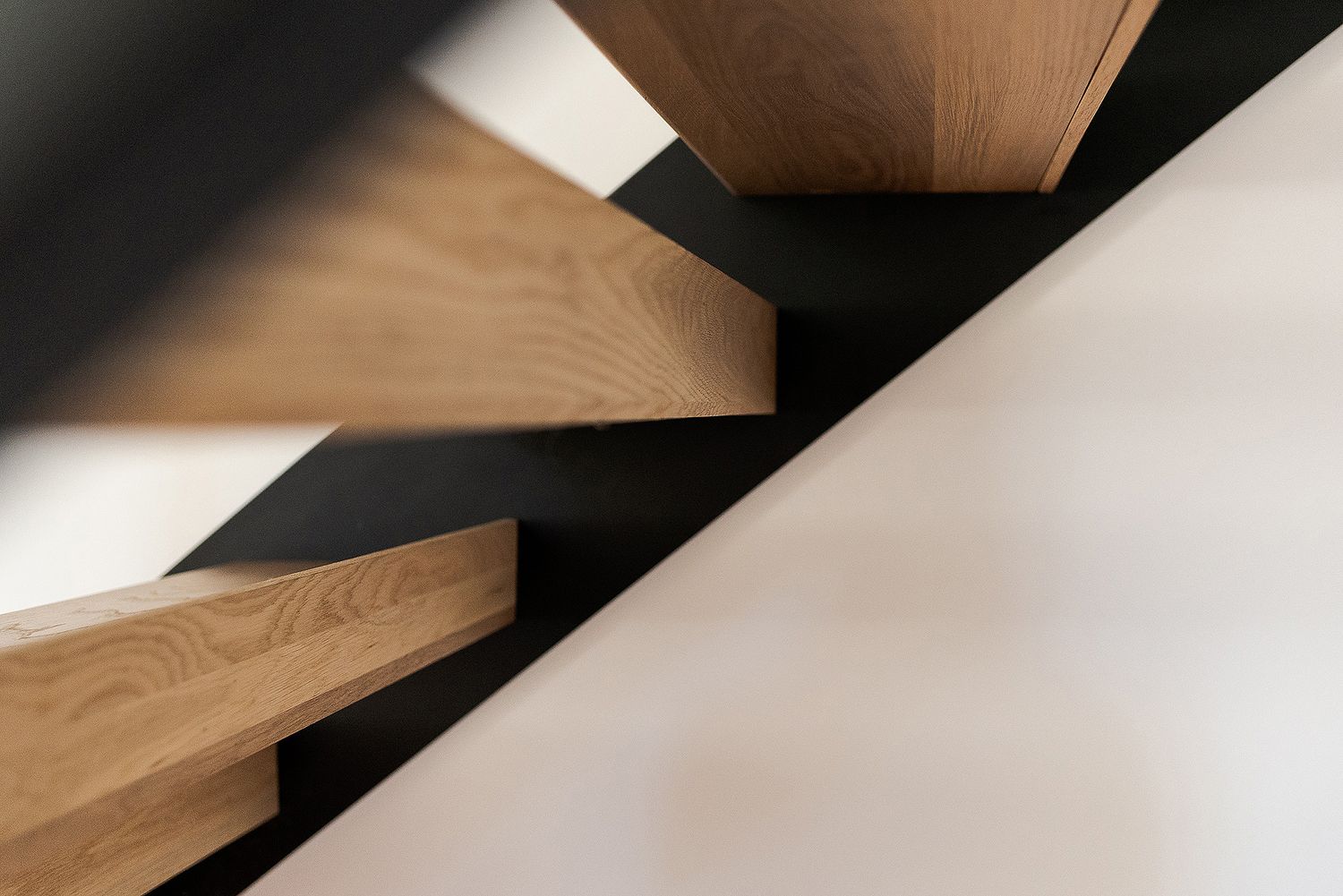 Close-up view of wooden slats forming a geometric pattern with diagonal lines and shadows.