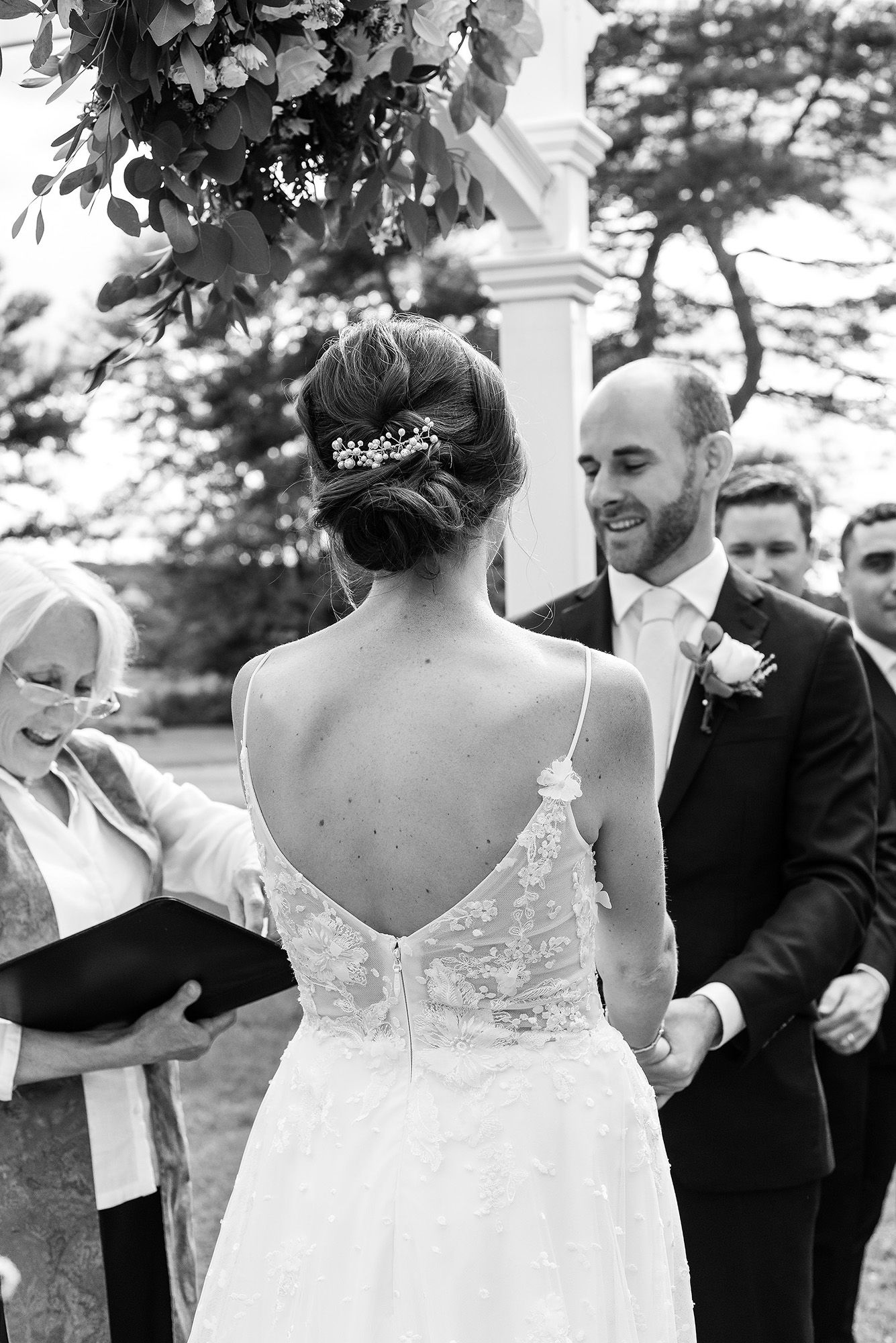 A series of candid black and white wedding photos showing tender moments between newlyweds during their celebration.