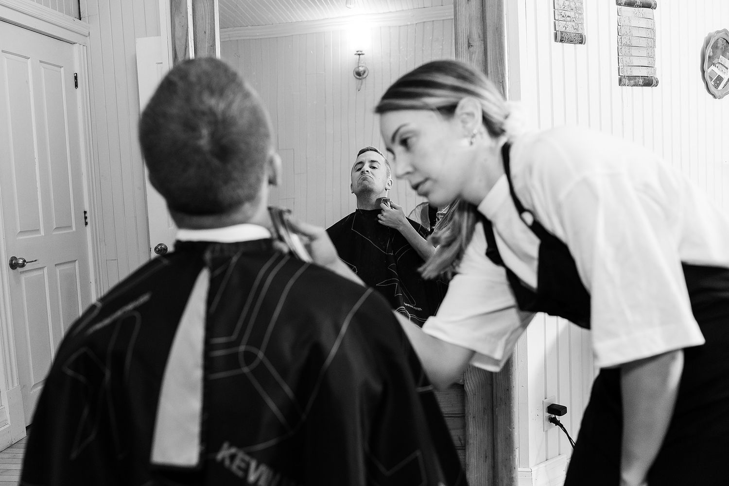 A black and white photo shows two students in a hallway having an intense conversation near lockers.