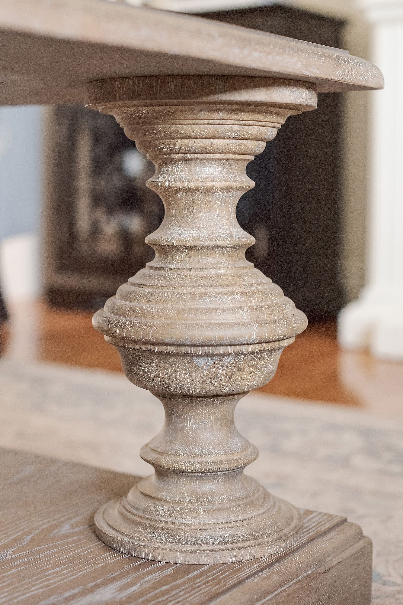 Close-up sequence showing ornate turned wood pedestal details with whitewashed finish and decorative grooves.