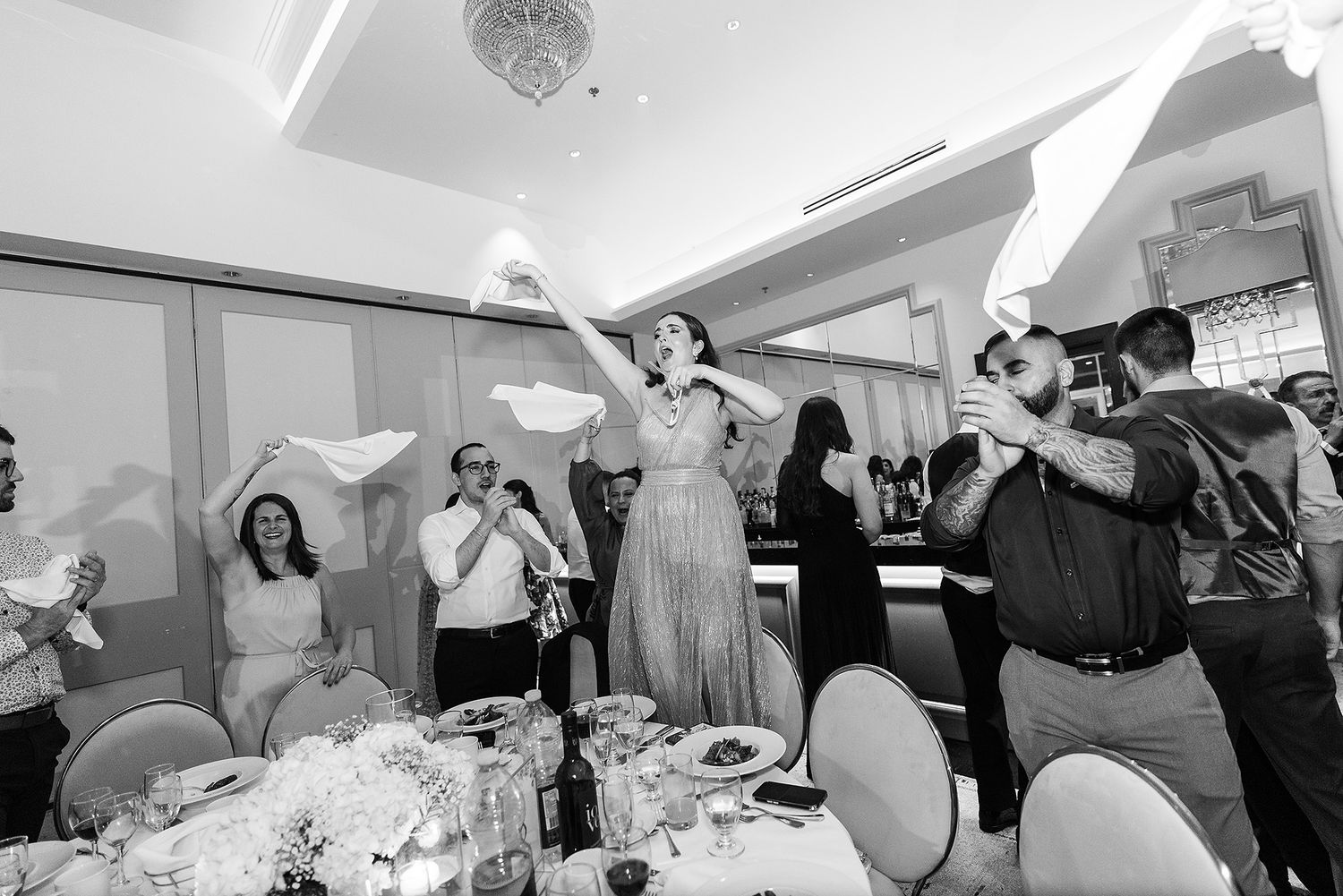 A series of black and white wedding reception photos showing dancing, celebration and joyful moments on the dance floor.
