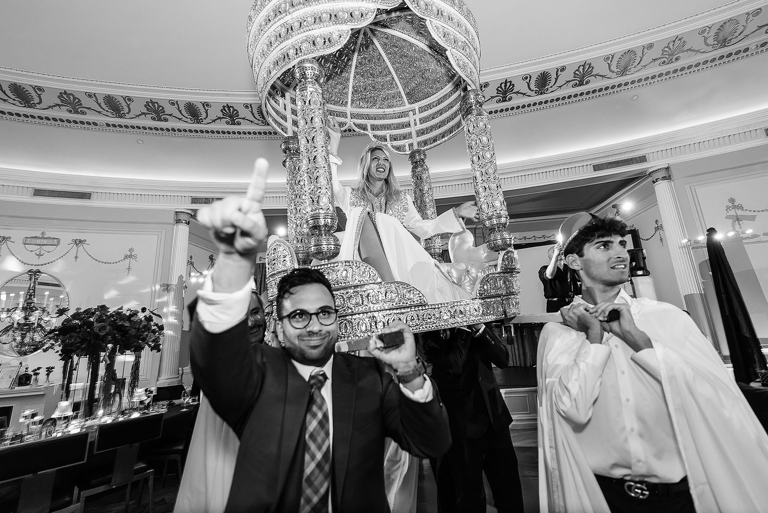 Black and white wedding reception photos show dancing, toasts, and celebration moments at an elegant indoor venue.