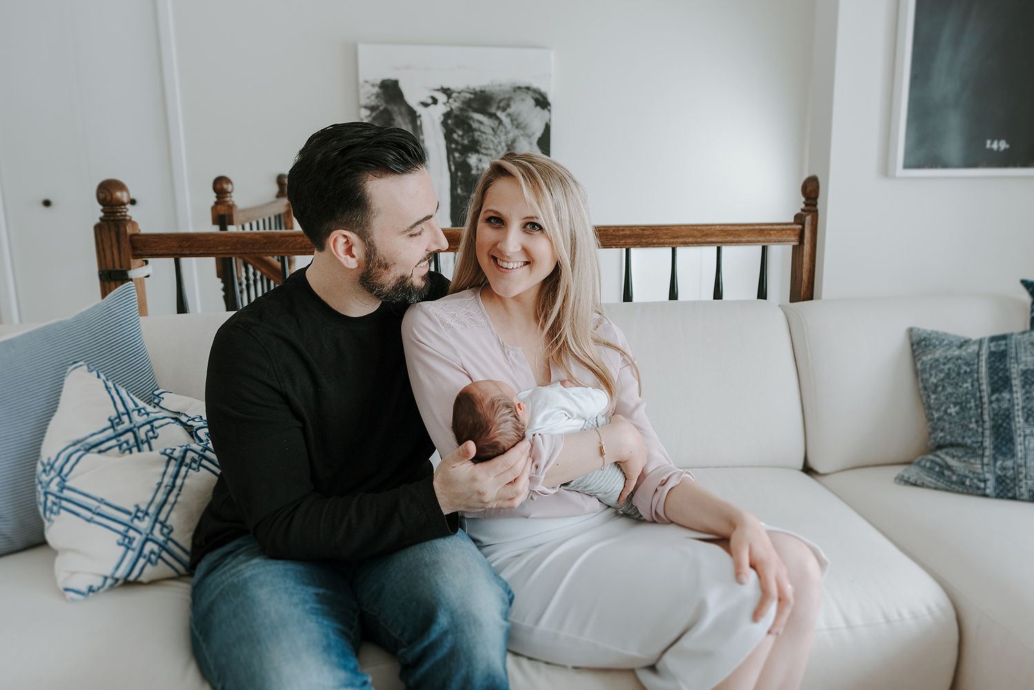 Lifestyle newborn photography in bright modern home setting.