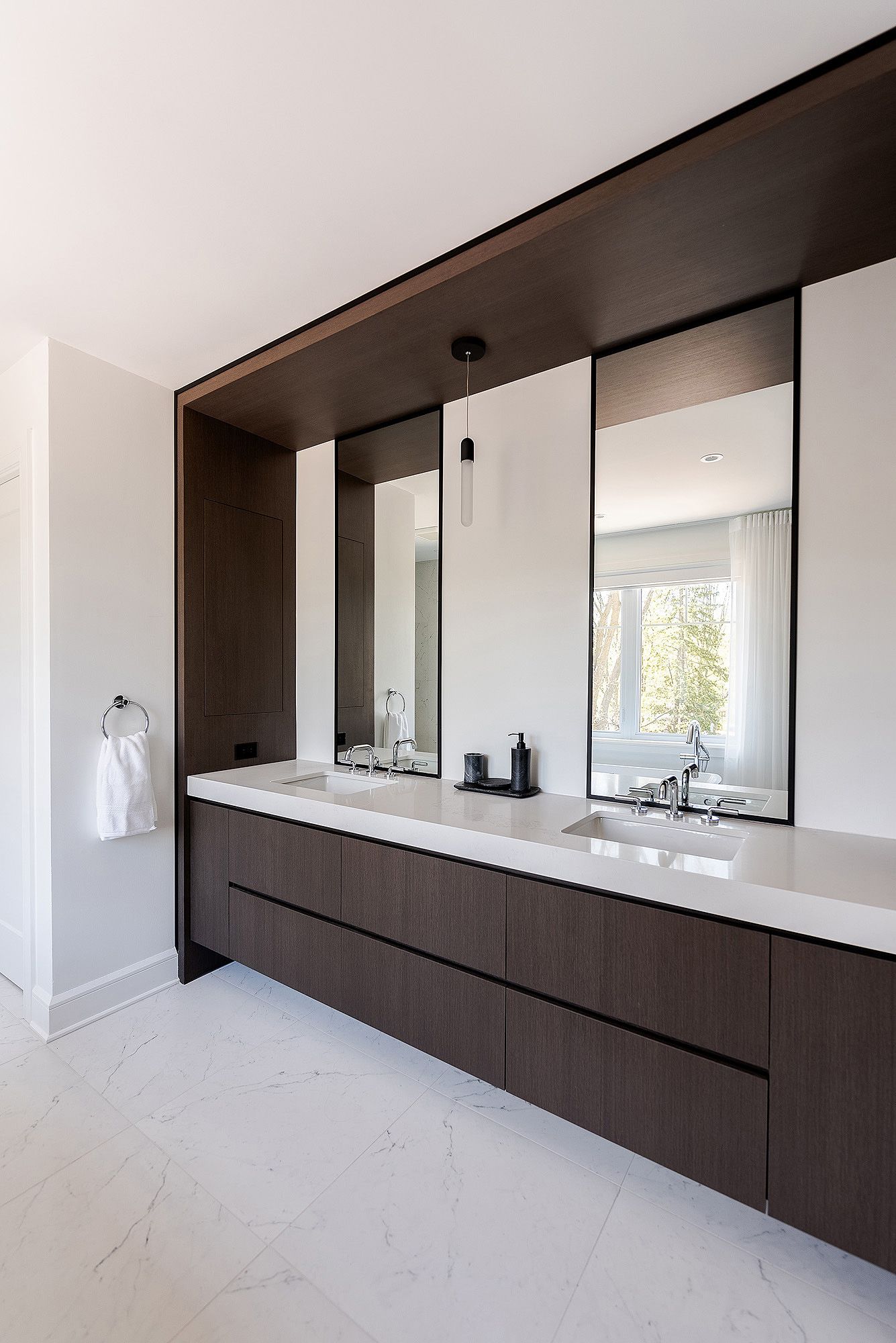 Modern kitchen interior with dark wood cabinets, white countertops and sleek cutout window openings in minimalist style.