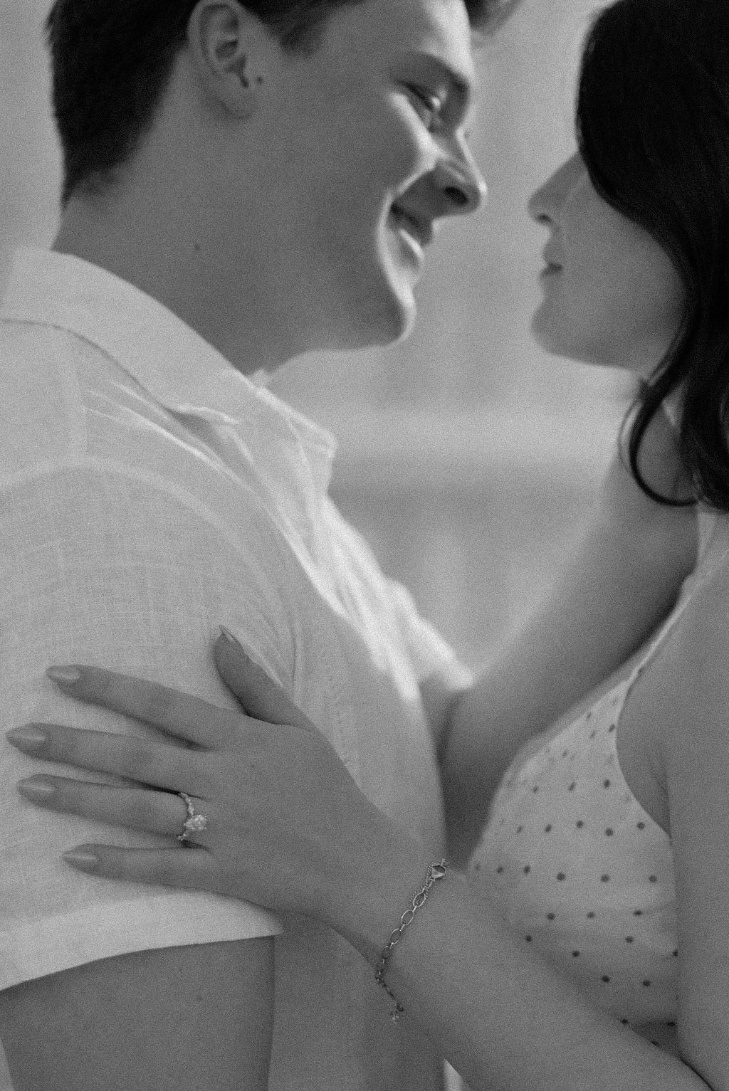 A romantic black and white photo sequence showing a tender embrace between a couple in intimate poses.