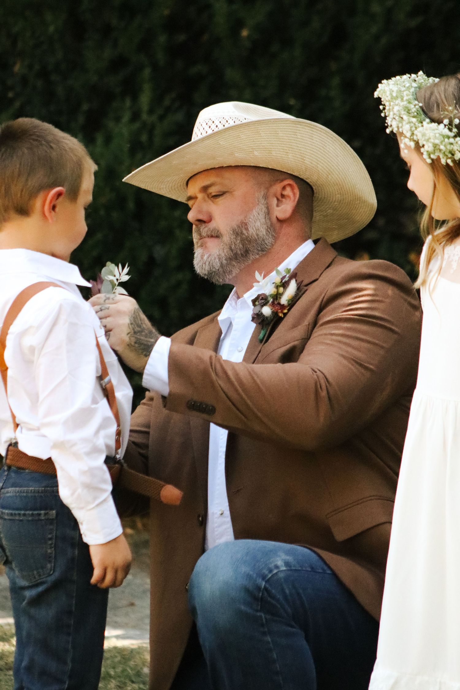 Sweet moment captured during outdoor country-style wedding ceremony.