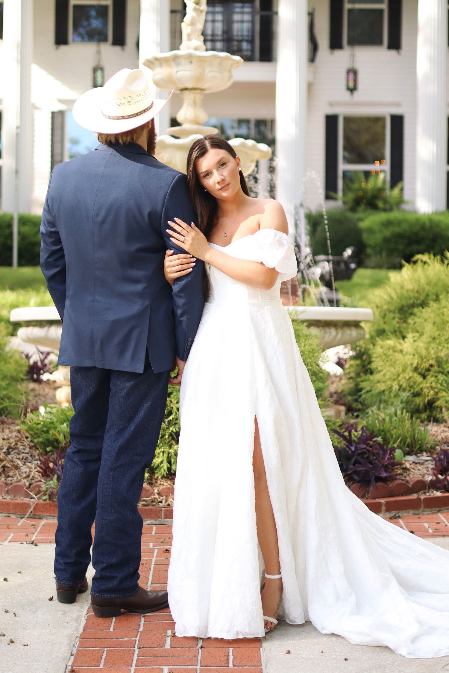 Romantic wedding portraits captured in front of a classic white columned building.